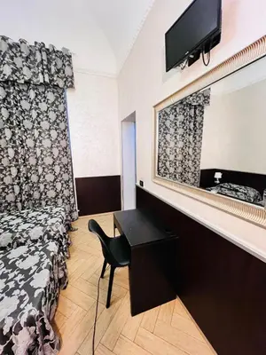a room with a bed and a mirror and a chair at Funny place in Rome