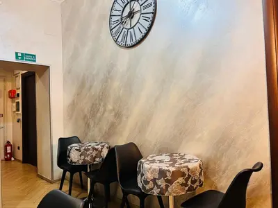 a room with chairs and a clock on the wall at Funny place in Rome
