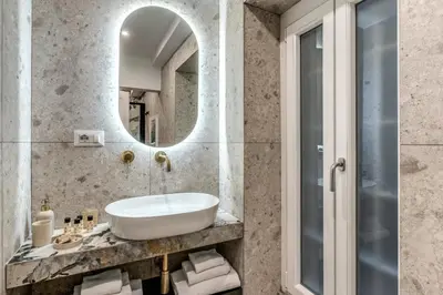 a bathroom with a sink and a mirror at Appartamento del Fico in Rome