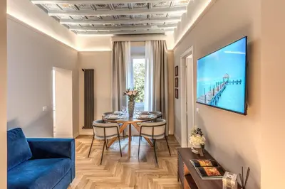 a living room with a blue couch and a table at Appartamento del Fico in Rome