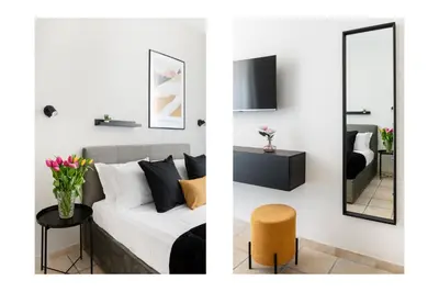 a living room with a white couch and a mirror at V HOME San Lorenzo in Rome