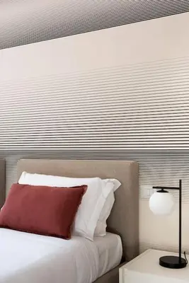 a bedroom with a bed with a red pillow and a lamp at Idyllia - Magnificent Central Apartment in Rome