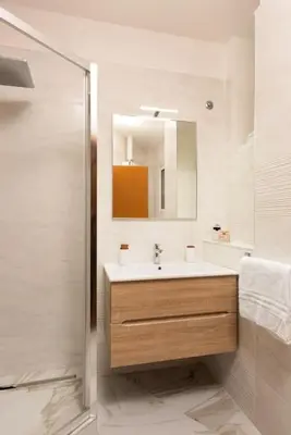 a bathroom with a sink and a mirror at Idyllia - Magnificent Central Apartment in Rome
