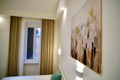 a hotel room with a painting on the wall at Maison Almo Guesthouse in Rome