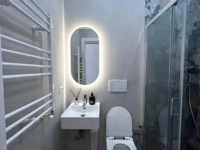 a bathroom with a sink and a toilet and a mirror at Maison Almo Guesthouse in Rome