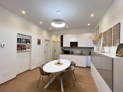 a kitchen and dining room with a white table and chairs at Maison Almo Guesthouse in Rome