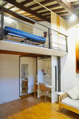 a room with a bunk bed and a living room at Trastevere Lovely Loft in Rome
