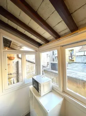 a microwave sitting on a counter in a room with windows at Trastevere Lovely Loft in Rome