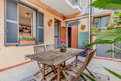 a wooden table and chairs on a patio at The ancient volute guest house in Rome