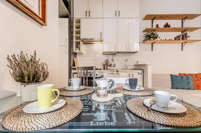 a kitchen with a table with cups and saucers on it at The ancient volute guest house in Rome