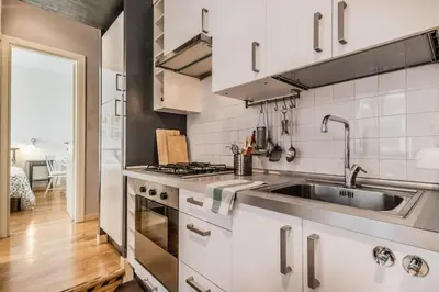 a kitchen with a sink and a stove at The ancient volute guest house in Rome