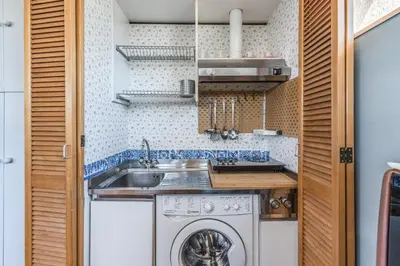 a small kitchen with a sink and a washing machine at Romantic Vatican Attic Villa Pamphili in Rome