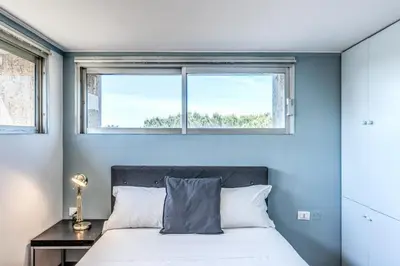 a bedroom with a bed and a window at Romantic Vatican Attic Villa Pamphili in Rome