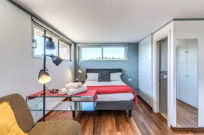 a bedroom with a bed and a glass table at Romantic Vatican Attic Villa Pamphili in Rome