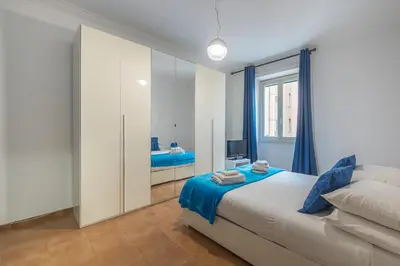 a bedroom with a bed and a mirror at Orange Blue House 1Bedr Metro Re di Roma in Rome