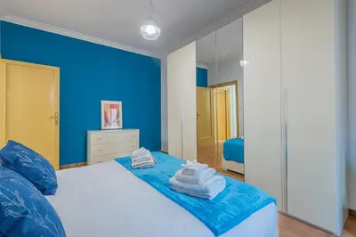 a blue bedroom with a bed with towels on it at Orange Blue House 1Bedr Metro Re di Roma in Rome