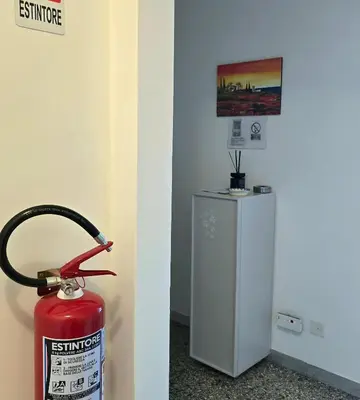 a fire hydrant sitting next to a fire extinguisher at Domus Passerini in Rome