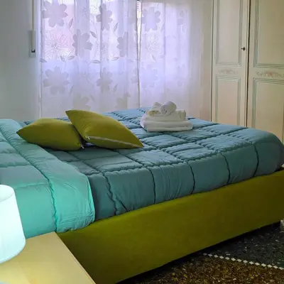 a blue bed with pillows and towels on it at Domus Passerini in Rome