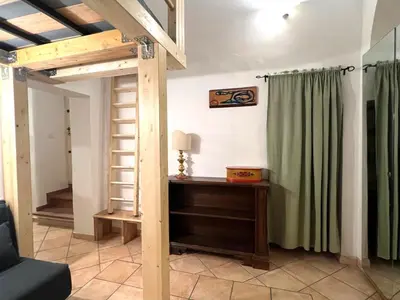 a living room with a loft bed and a table at Daisy House in Rome