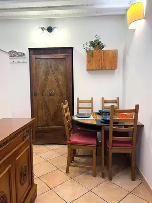 a dining room with a table and chairs and a door at Daisy House in Rome