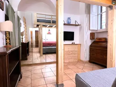 a bedroom with a bed and a television in a room at Daisy House in Rome