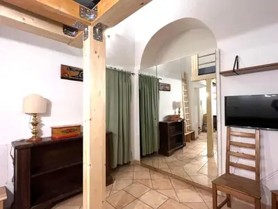 a living room with a television and green curtains at Daisy House in Rome