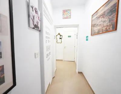 a hallway with art on the walls of a room at Key Rome Center in Rome