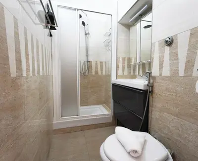a bathroom with a toilet and a shower and a sink at Key Rome Center in Rome