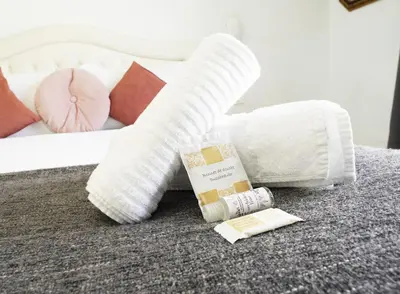 a bed with white blankets and pillows on the floor at Key Rome Center in Rome