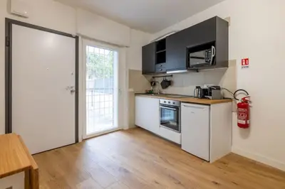 a kitchen with a stove and a refrigerator at Little House 15 in Rome