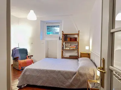 a small bedroom with a bed and a window at Alloggio Turistico al Villino del Melograno in Rome