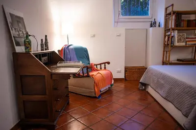 a bedroom with a desk and a bed and a desk at Alloggio Turistico al Villino del Melograno in Rome