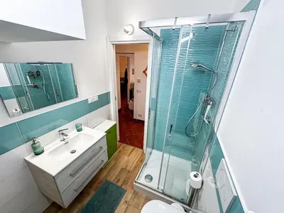 a bathroom with a glass shower and a sink at Alloggio Turistico al Villino del Melograno in Rome