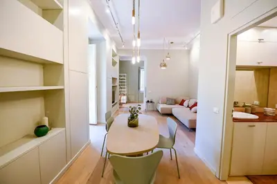 a dining room and living room with a table and chairs at Il Giardino della Musa in Rome