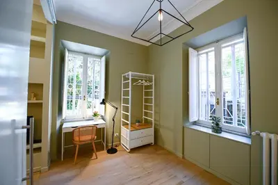 a room with a desk and two windows at Il Giardino della Musa in Rome