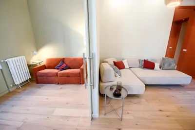 a living room with a couch and a chair at Il Giardino della Musa in Rome