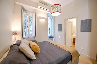 a bedroom with a large bed with pillows on it at Il Giardino della Musa in Rome