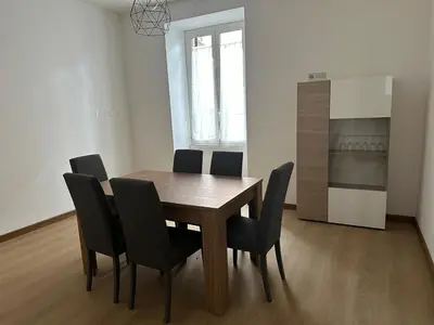 a dining room with a wooden table and black chairs at Maison Niccolini Gianicolo in Rome