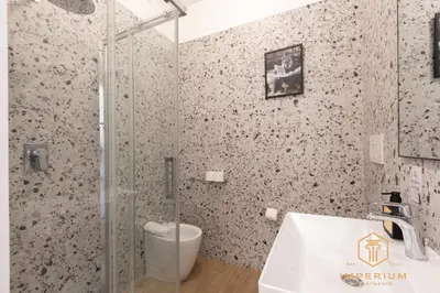 a bathroom with a glass shower and a sink at Imperium Luxury Suites - 100mt to Metro A, 5 min to center, pvt bathroom, A-C in Rome