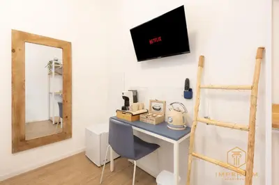 a desk in a room with a mirror at Imperium Luxury Suites - 100mt to Metro A, 5 min to center, pvt bathroom, A-C in Rome