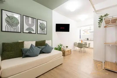a living room with a couch and a table at Imperium Luxury Suites - 100mt to Metro A, 5 min to center, pvt bathroom, A-C in Rome
