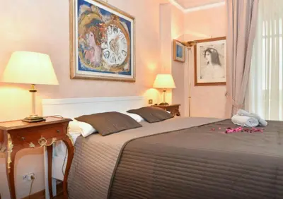 a bedroom with two beds and two lamps at B&B Classy Rome in Rome