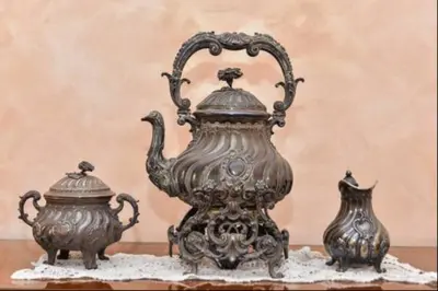 a tea pot and a vase on a table at B&B Classy Rome in Rome