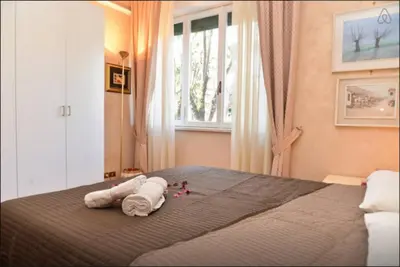 a bedroom with a bed with towels and dolls on it at B&B Classy Rome in Rome