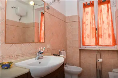 a bathroom with a sink and a toilet and a mirror at B&B Classy Rome in Rome