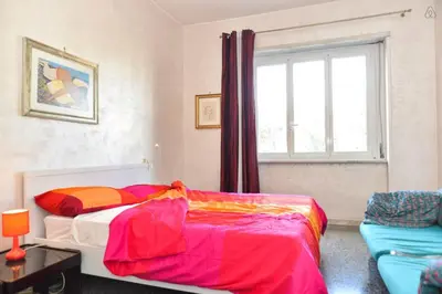 a bedroom with a bed and a window and a couch at B&B Classy Rome in Rome
