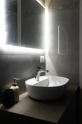 a white sink in a bathroom with a mirror at Imperia House in Rome