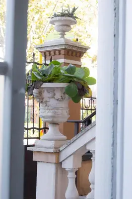 a vase with a plant in it on a railing at Imperia House in Rome