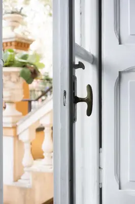 a door handle on a door with a staircase at Imperia House in Rome