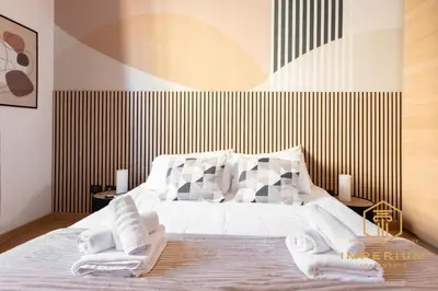 a bedroom with a bed with two towels on it at Imperium Deluxe Apt - 300mt to Metro B, 3 bedrooms, Panoramic view, A-C in Rome